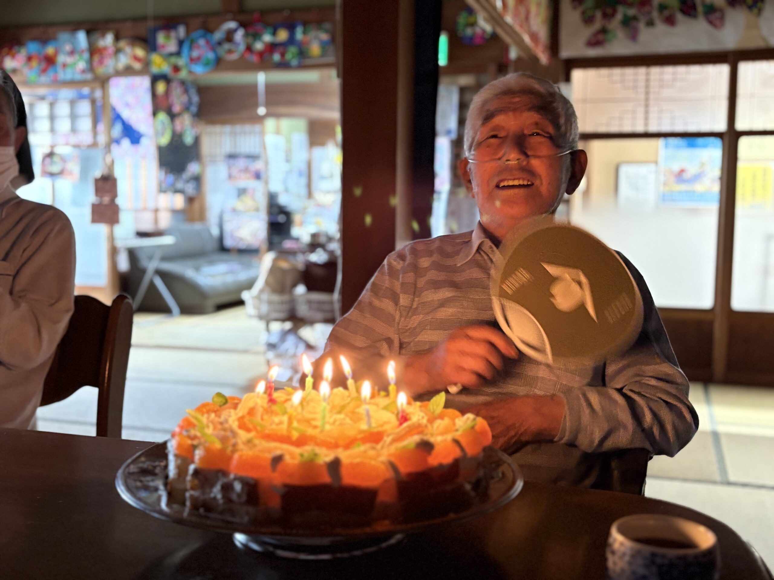 お誕生日ケーキを前に幸せいっぱいの笑顔